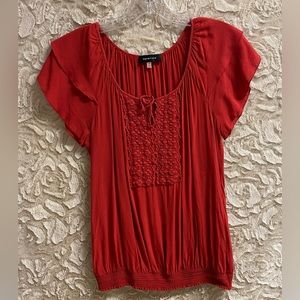 Rust/burnt orange color women’s blouse by Spense. Size medium.